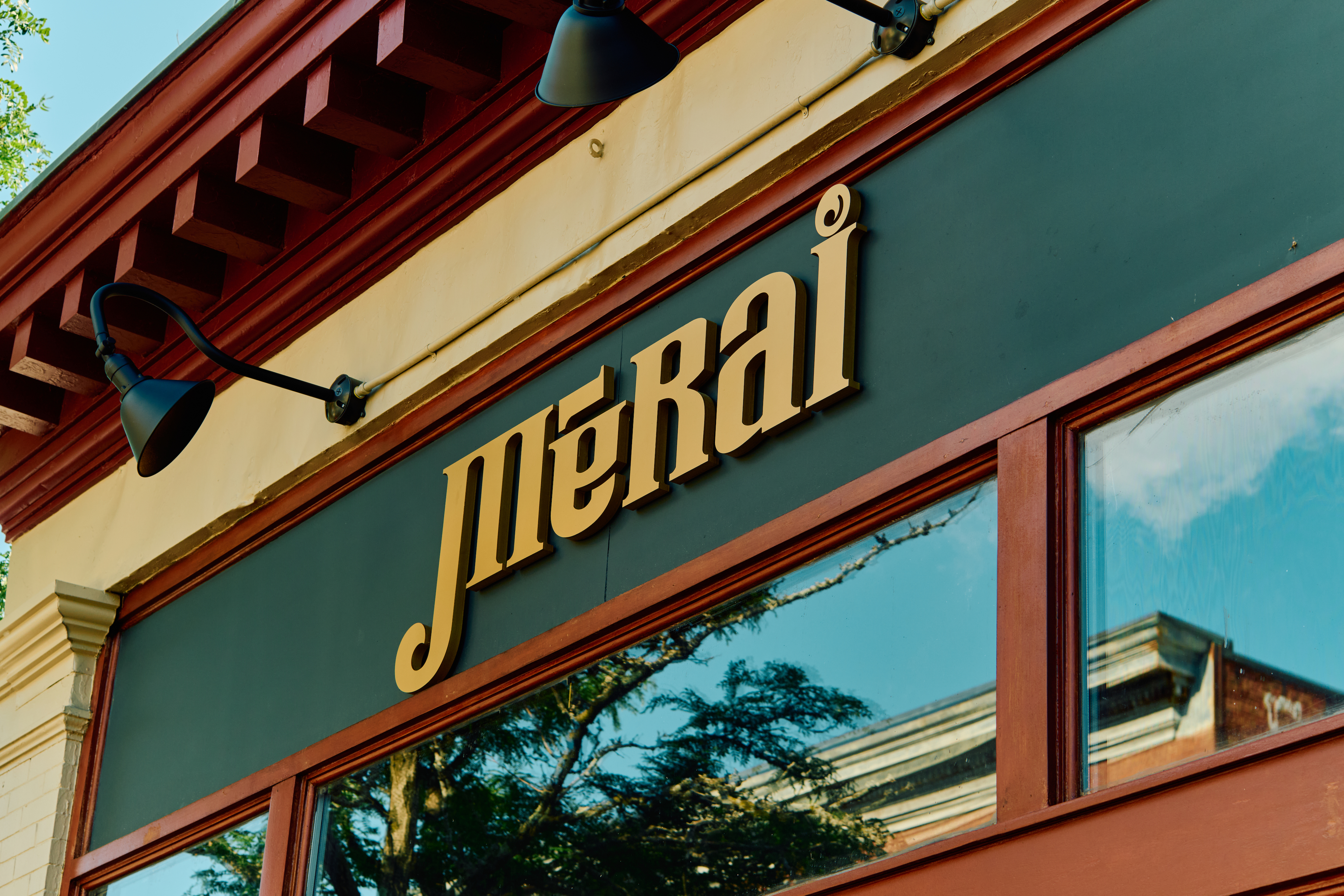 The exterior of Merai, with the bar title in block gold letters on the side of the building.