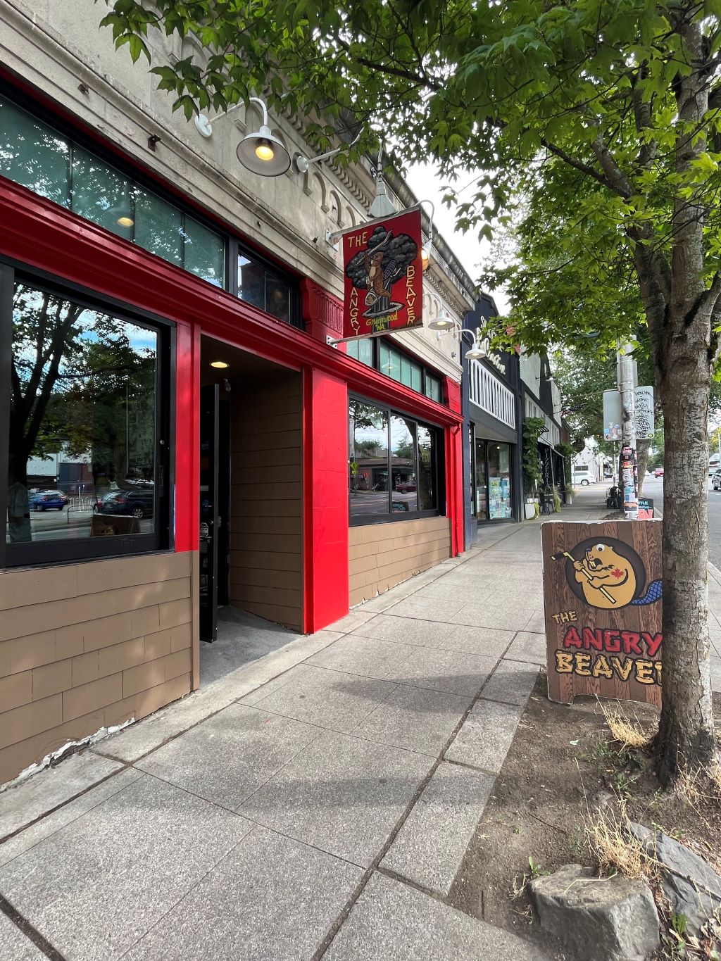 The exterior of a bar with a sign outside that says, “The Angry Beaver.”