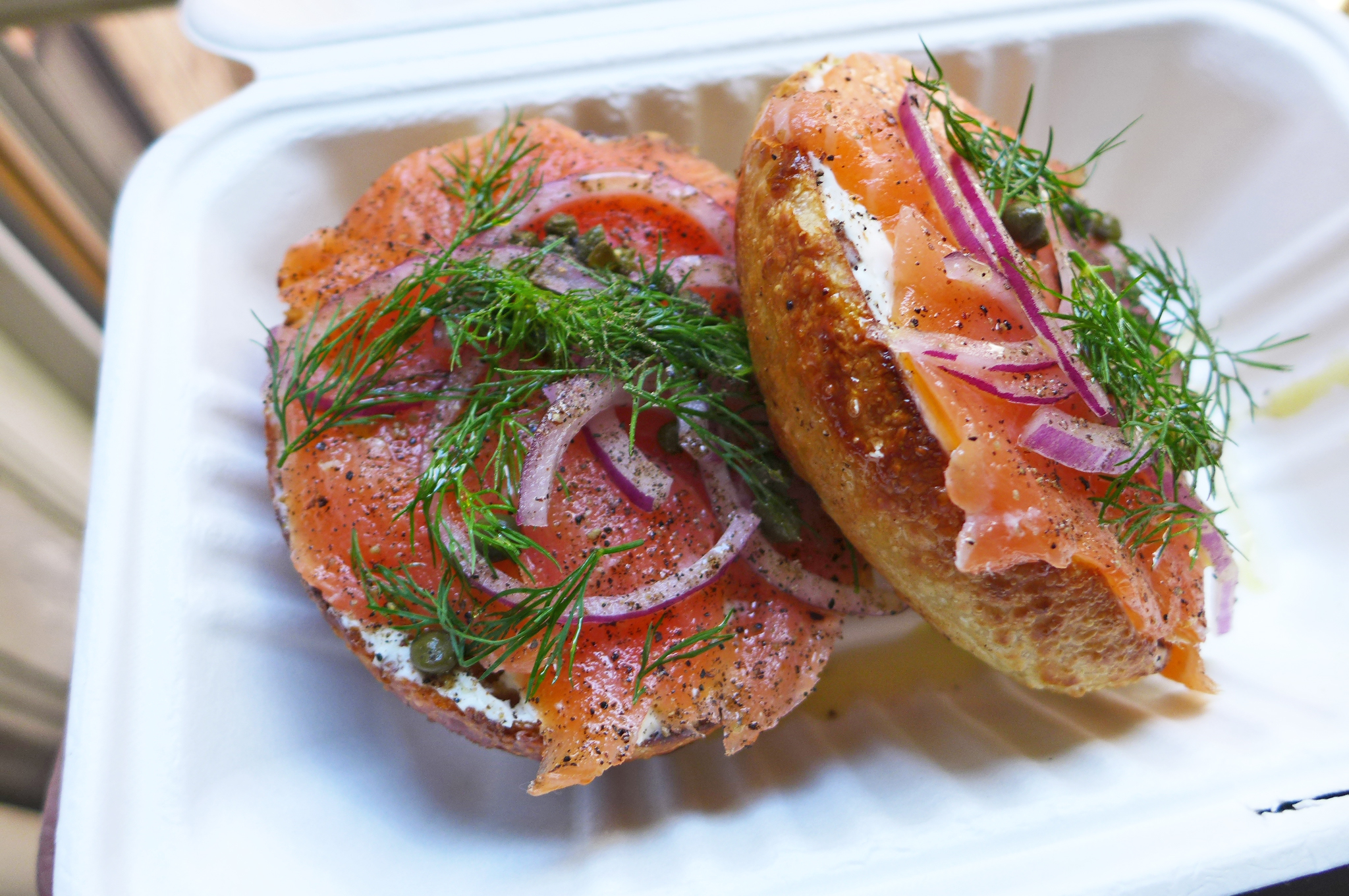 Open faced bagel sandwich with orange smoked salmon.