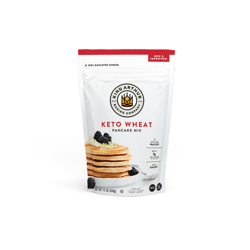 Front of Keto Wheat Pancake Mix package. White bag with a stack of pancakes topped with raspberries and whipped cream.