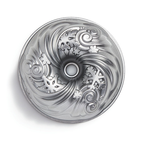 Let it Snow Bundt Pan from side. Silver color tube shaped pan with swirling snowflakes.