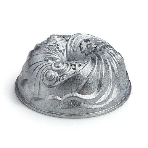 Let it Snow Bundt Pan from side. Silver color tube shaped pan with swirling snowflakes.