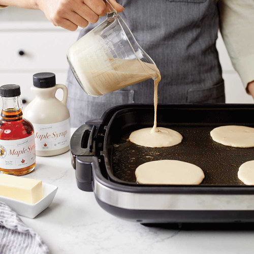 Baker making pancakes using Zojirushi Gourmet Sizzler Electric Griddle