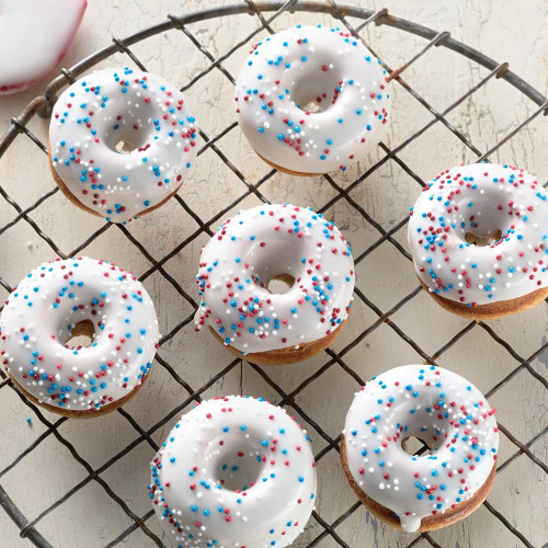 Buttermilk Doughnut made from Buttermilk Doughnut Mix and Mini Doughnut Pan Set with white glaze and sprinkles