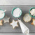 View White Icing Mix in a bowl with iced star cookies and piping bag