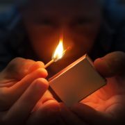 Child holding lit match