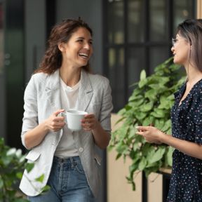 Friends at work sharing coffee break.