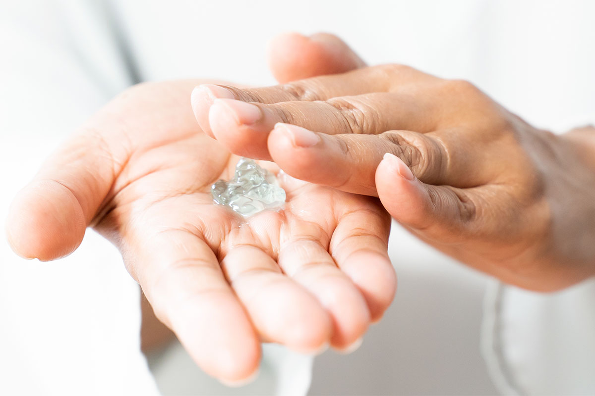 A person using hand sanitizer