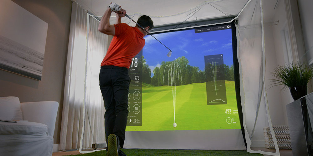 A person using a golf simulator.