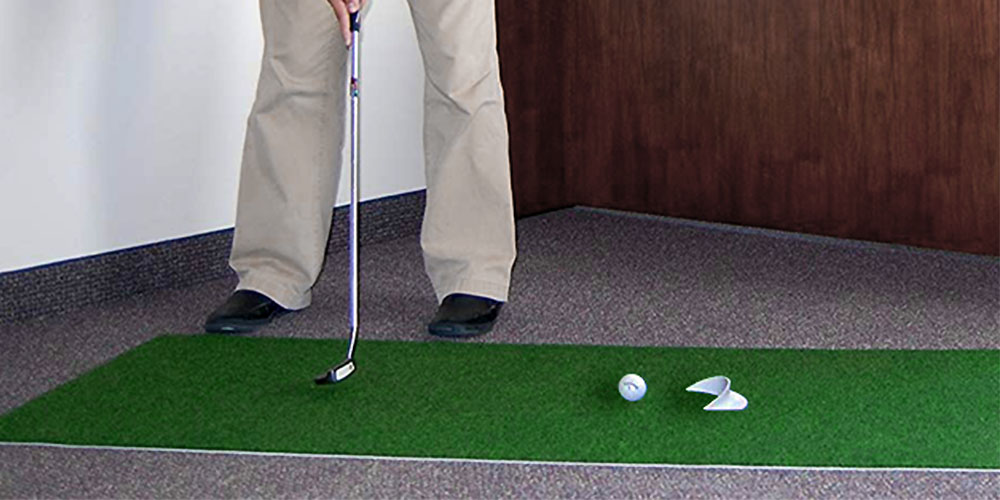 A person using a putting mat.