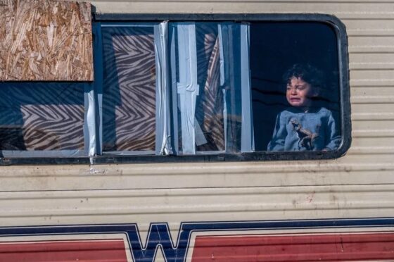 Little boy crying at window of an RV