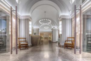 a lobby with chairs and a podium in a building at Hotel Martis Palace in Rome