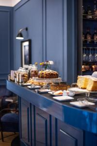 a buffet with cakes and other food on a table at The Fifteen Keys Hotel in Rome