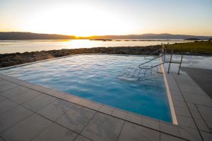 a swimming pool with a chair in front of the water at Portavadie Loch Fyne Scotland in Portavadie