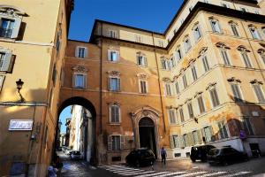 a large building with an arch in a street at Nerva Boutique Hotel in Rome