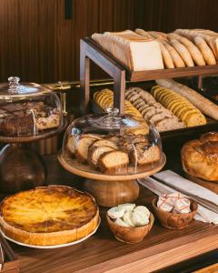 a display of different types of bread and pastries at Hôtel Des Grands Voyageurs in Paris