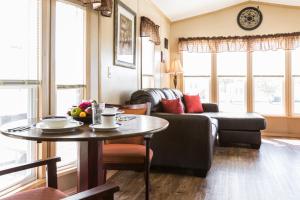 a living room with a couch and a table at Red Shoes RV Park and Chalets in Kinder