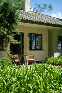 two chairs and a table in front of a house at Goatfell - Nuwara Eliya in Kandapola