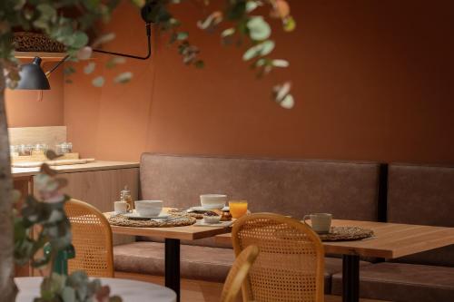 a table and chairs in a restaurant with food on it at TOC Hotel Las Ramblas in Barcelona