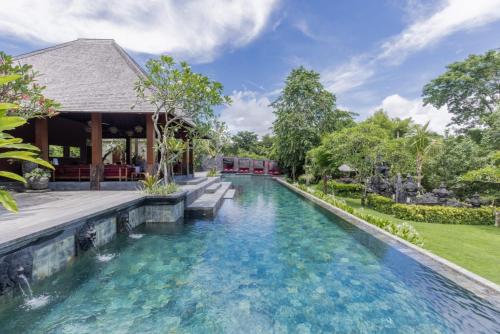 an infinity pool in the backyard of a house at La Reserve 1785 Canggu Beach in Canggu