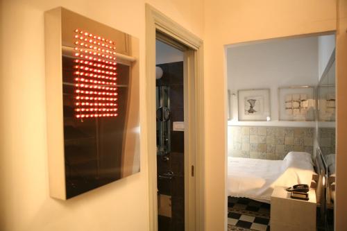 a door to a room with a bed and a mirror at Villa Laetitia in Rome