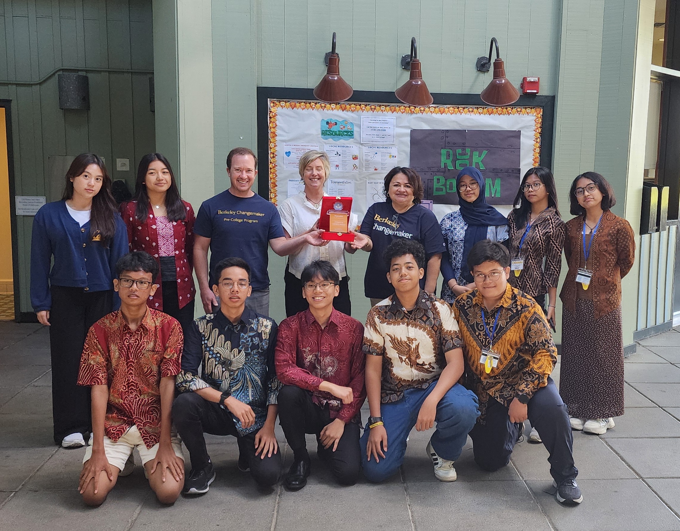 Students standing with program faculty at end of program