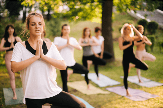 Group of women outside doing yoga