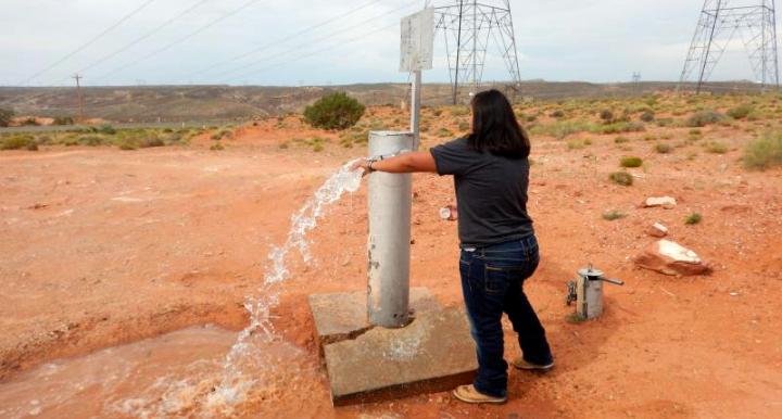 NAU graduate student Andee Lister collects a water sample from an unregulated well in the southwestern region of the Navajo Nation.