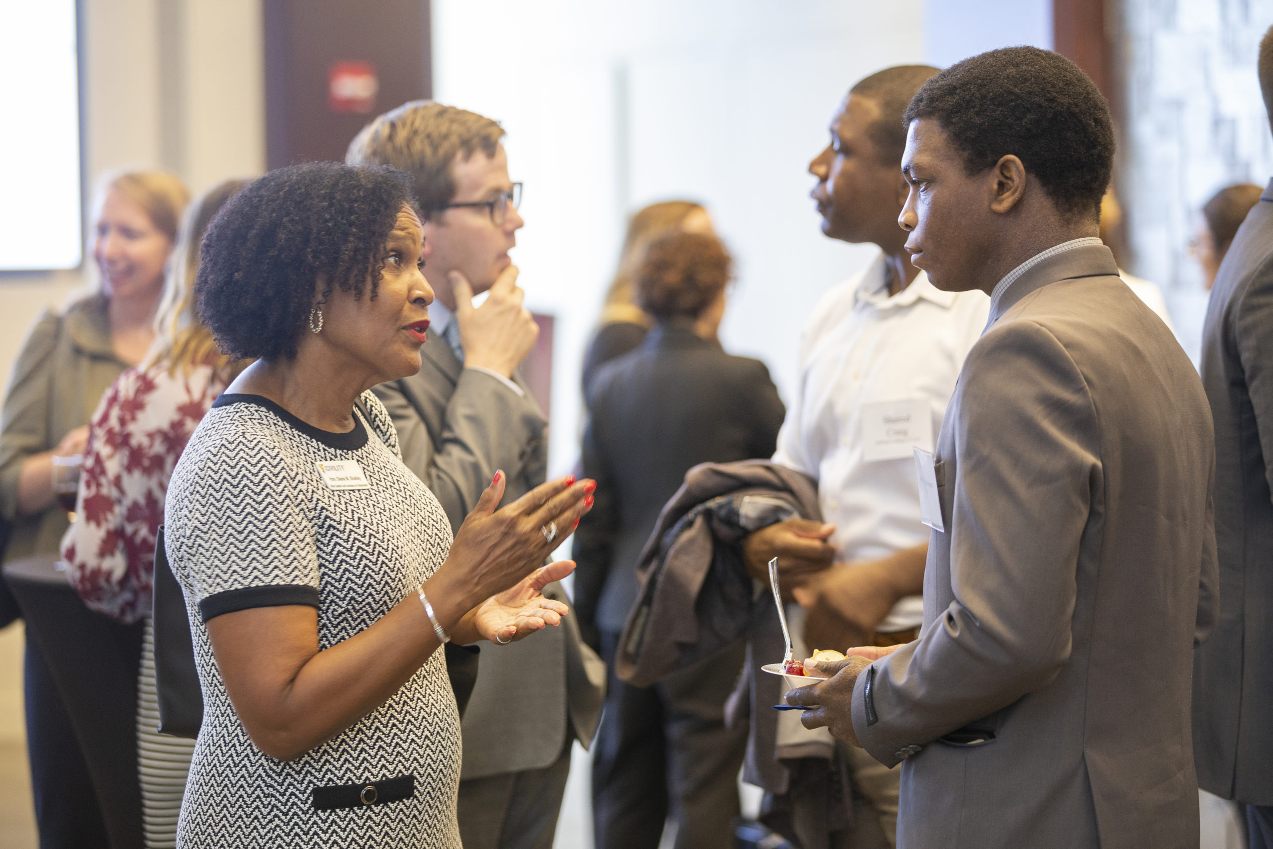 Judge Diane Shelley speaking with a young professional 