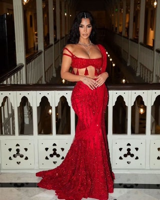 Image may contain Huda Kattan Clothing Dress Formal Wear Fashion Gown Evening Dress Wedding Wedding Gown and Adult