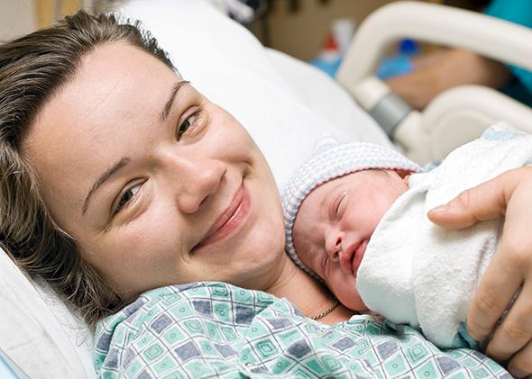 Happy mother with newborn baby