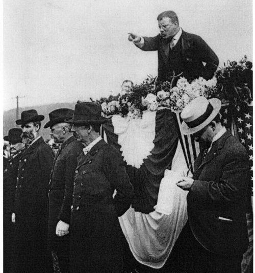 John F. Kennedy gives a manvotional speech on a horse.