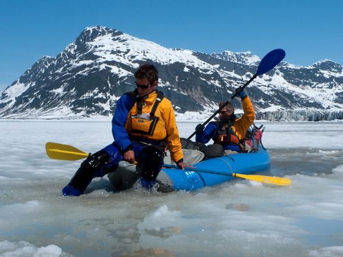 Andrew Skurka enjoying paddle rafting in ice river. 