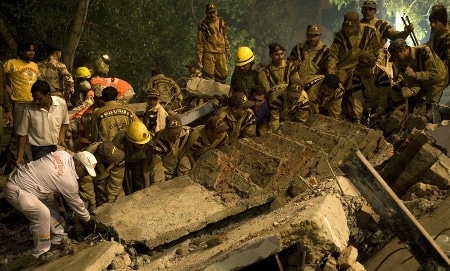 A group of people engaged in hero training, lifting an object amidst distress.