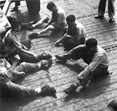 Vintage men sitting and playing mumblety-peg pocket knife.