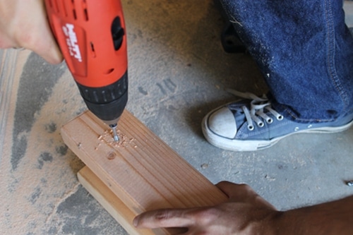 Making holes for a screw in a wood.