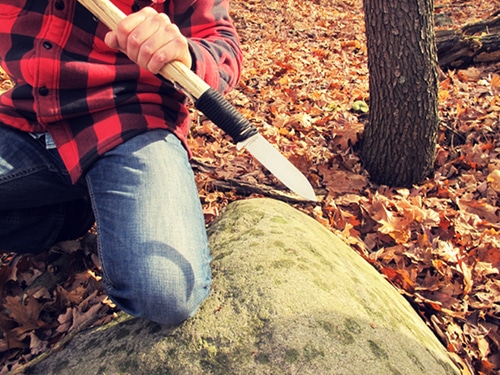 A man holding Survival weapon made with pocket knife.