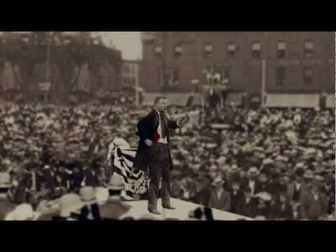 A strong as a bull moose man in a suit standing in front of a crowd, embodying moments in manliness.