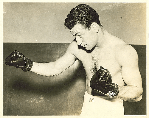 A man wearing boxing gloves throwing punches.