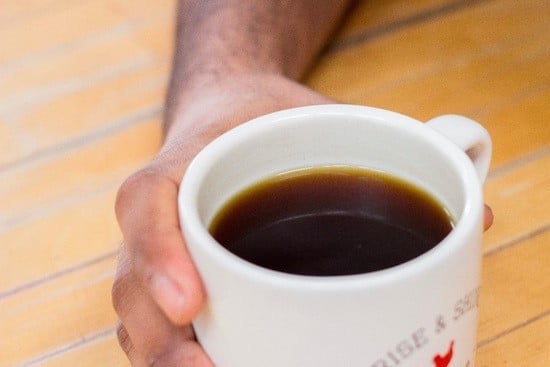 A hand holding a coffee mug.