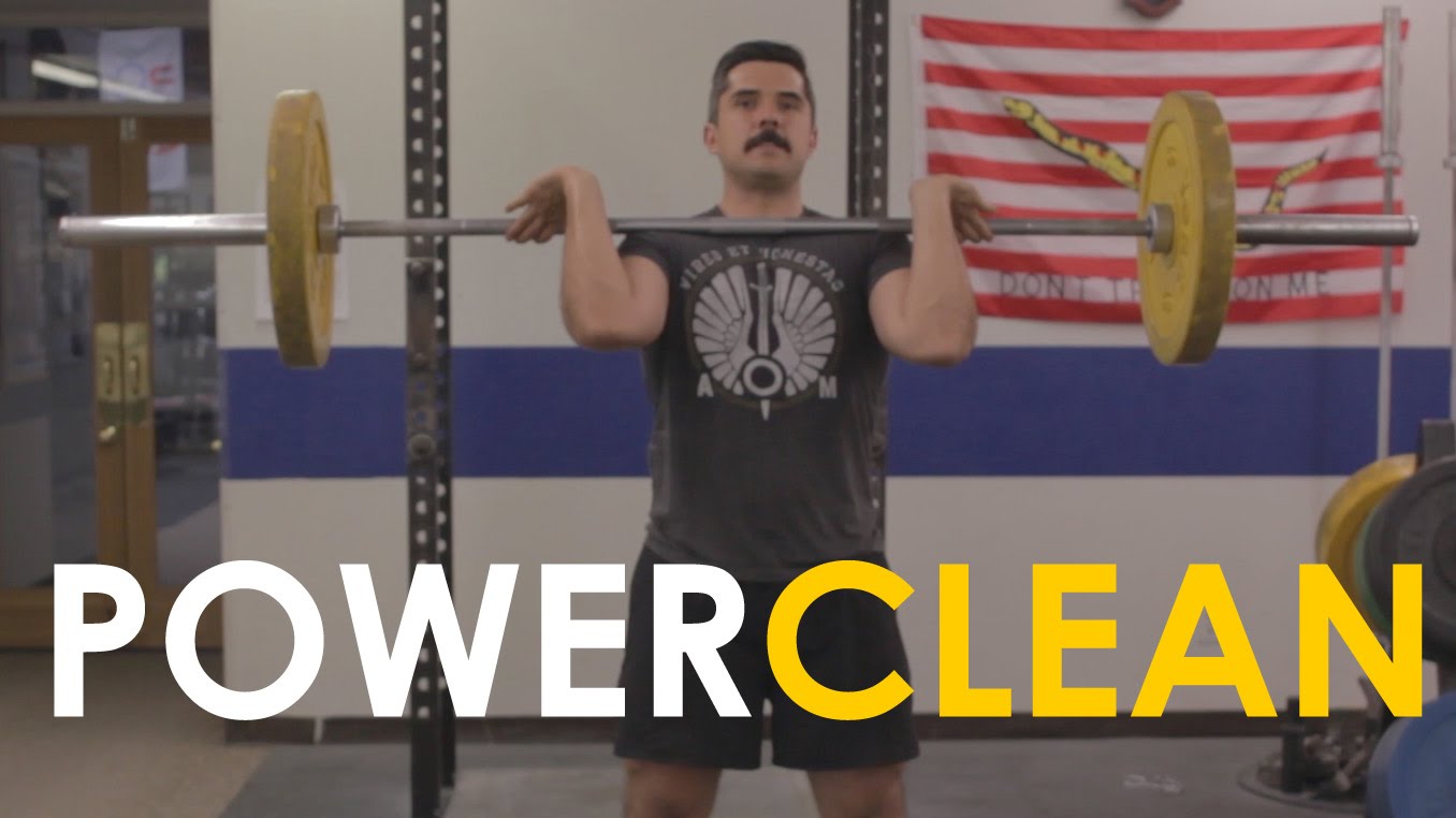 Learn how to power clean by watching this video of a man lifting a barbell in a gym.