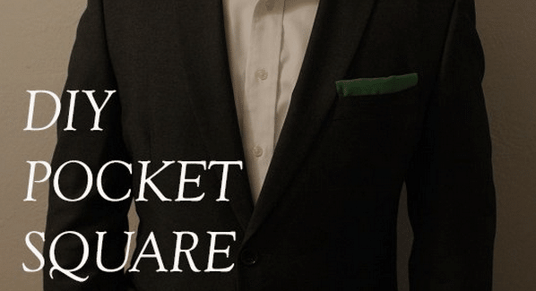 A man in a suit showcasing his DIY pocket square, no sewing required.