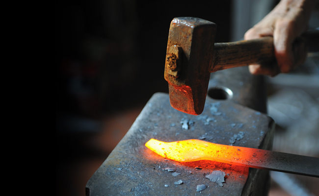 A person demonstrates virtue while working on a blacksmith's anvil on Sunday Firesides.