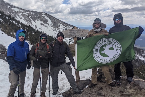 In May 2021, a group of people conquered a mountain peak, proudly waving a green flag.