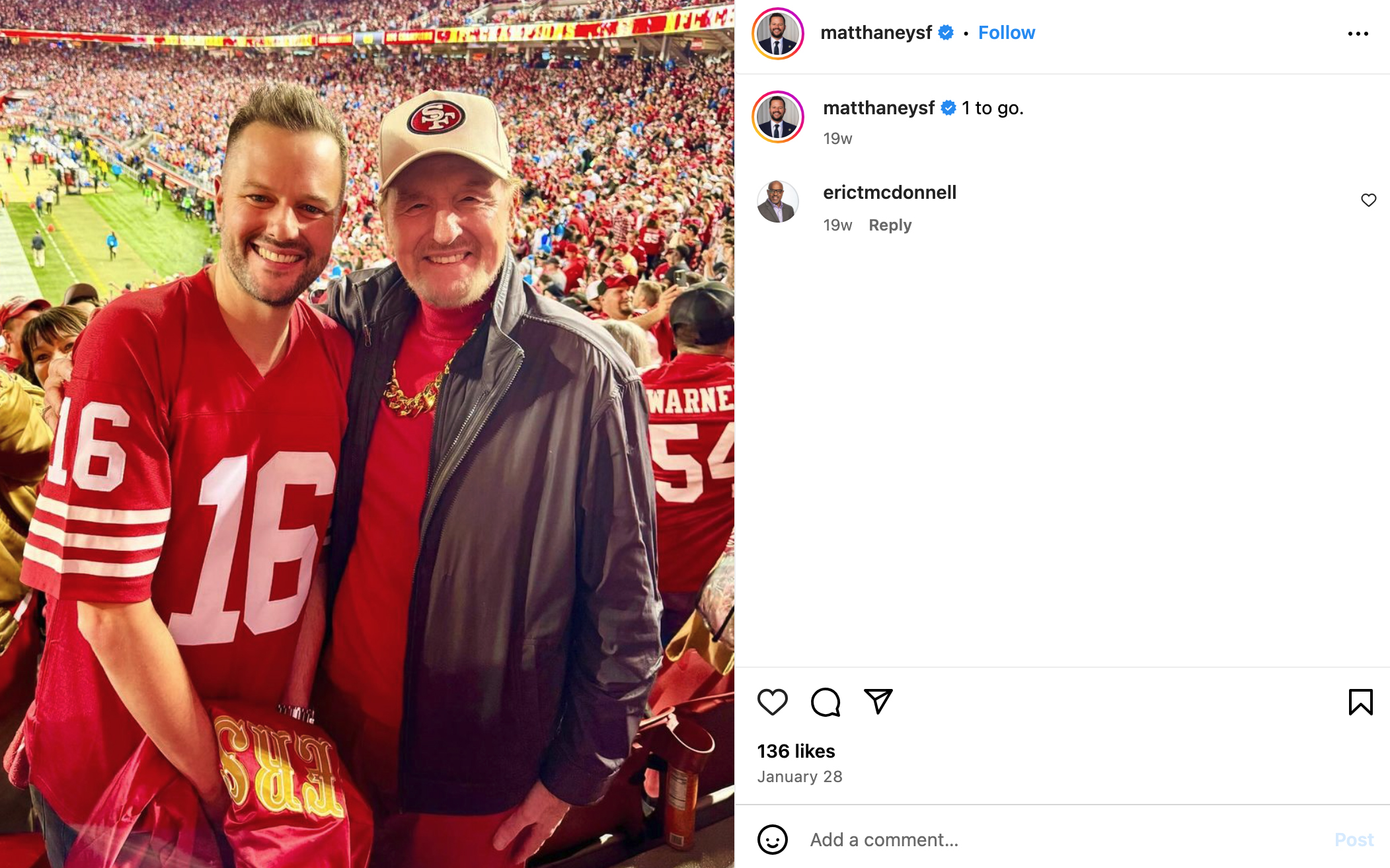 Matt Haney and his dad, Craig, in red jerseys, with the number &quot;16&quot; visible on one, stand in a crowded football stadium filled with fans wearing red.