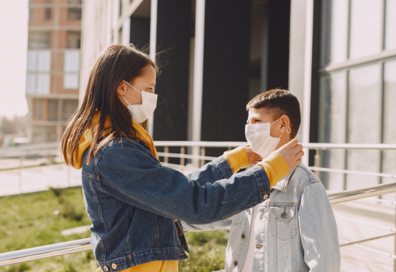 Two young people adjusting the covid mask