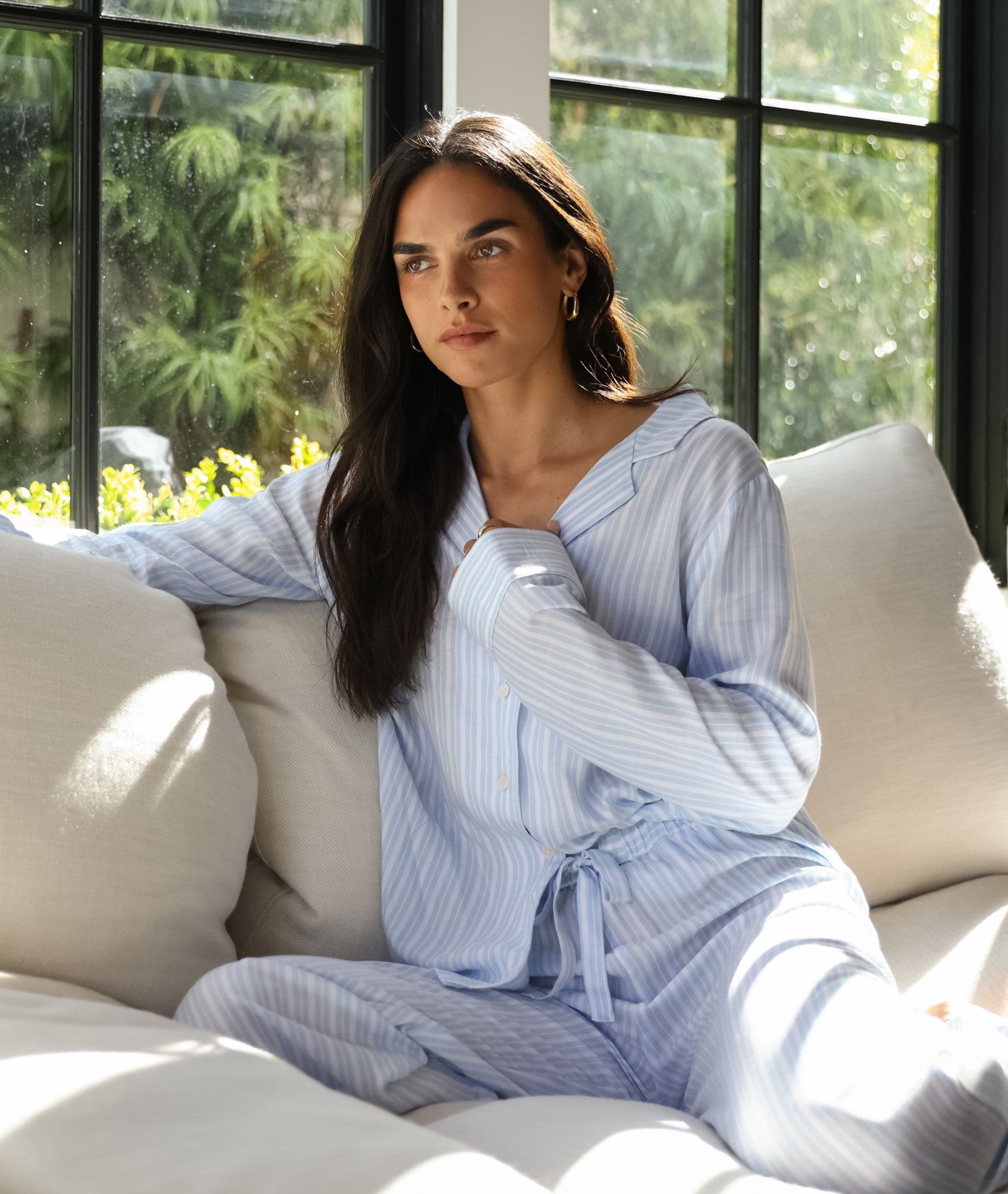 Women in Soft Woven pajamas sitting on couch