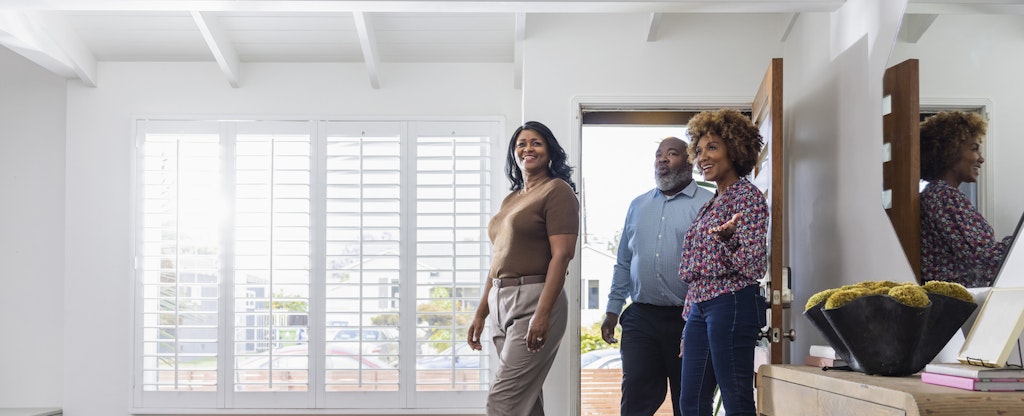 Young couple touring a home with their realtor