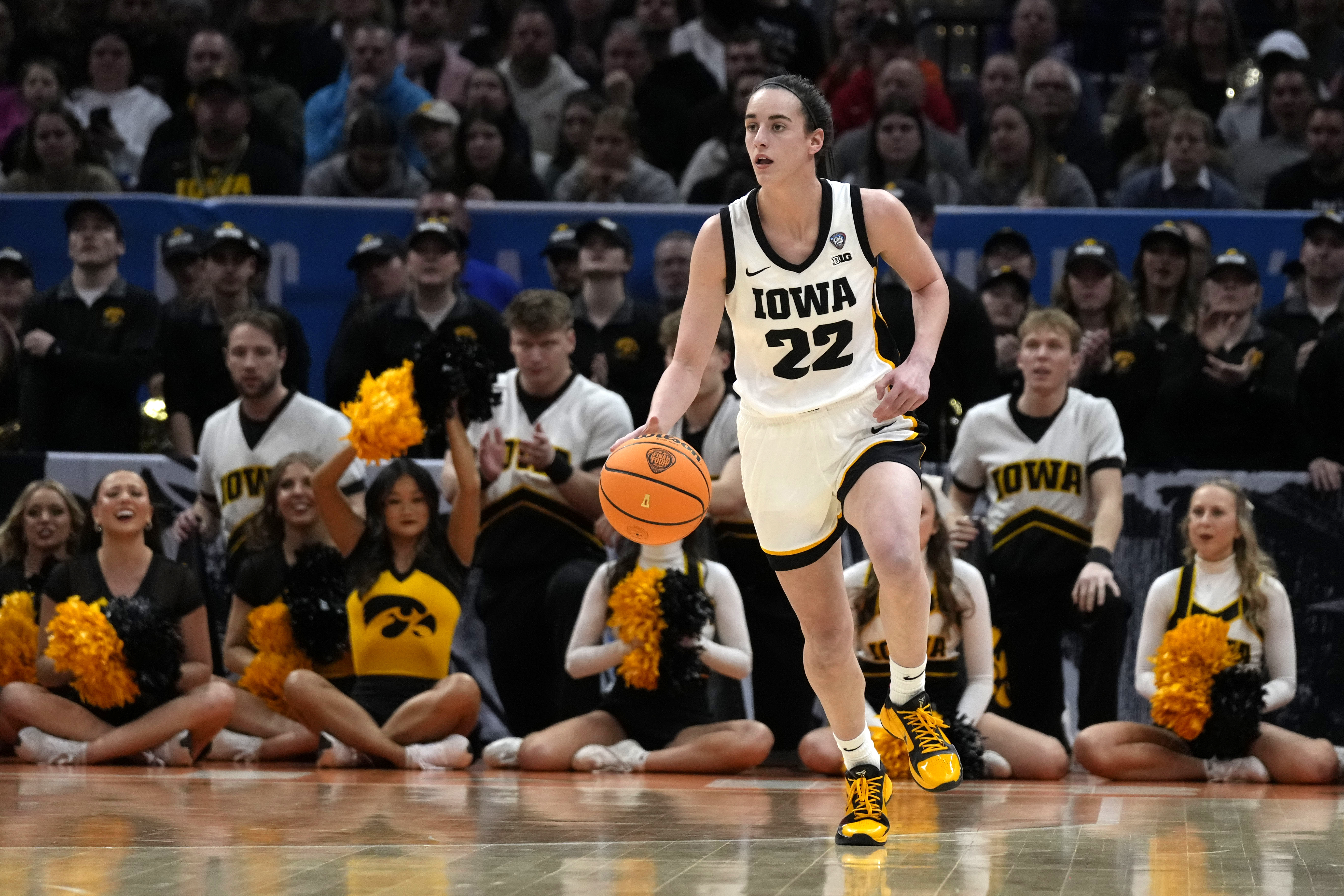 Iowa guard Caitlin Clark (22) drives up court during the first half of a Final Four college basketball game against UConn in the women's NCAA Tournament, Friday, April 5, 2024, in Cleveland. 