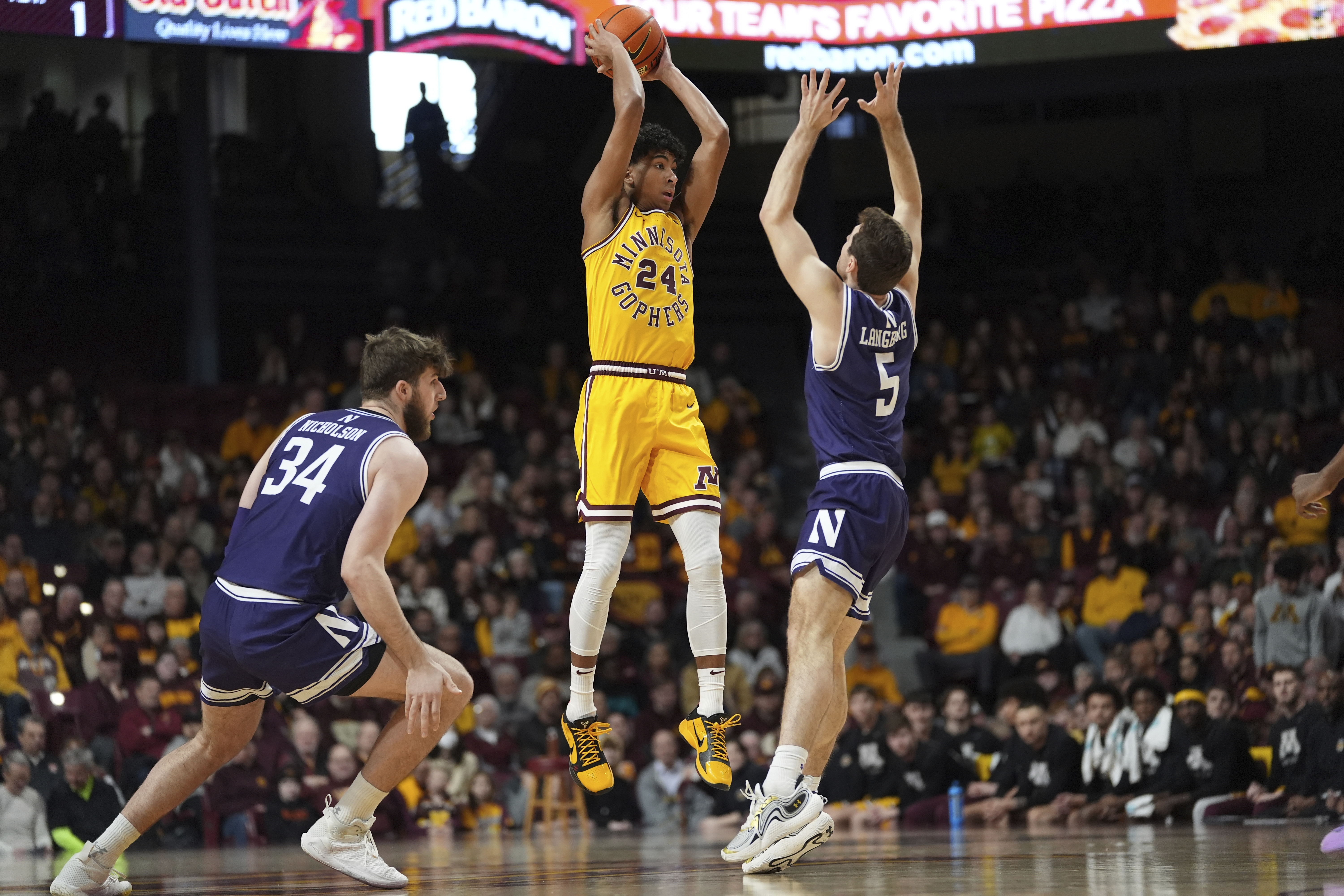 Minnesota guard Cam Christie (24) looks to pass as Northwestern center Matthew Nicholson (34) and guard Ryan Langborg (5) defend during the first half of an NCAA college basketball game Saturday, Feb. 3, 2024.